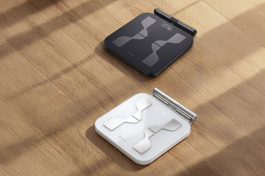 Black and white Hume Pod 2.0 analyzers on a sunlit wooden floor